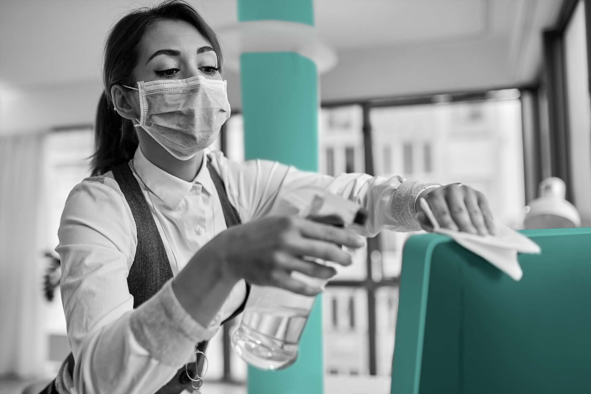 Woman cleaning office desk